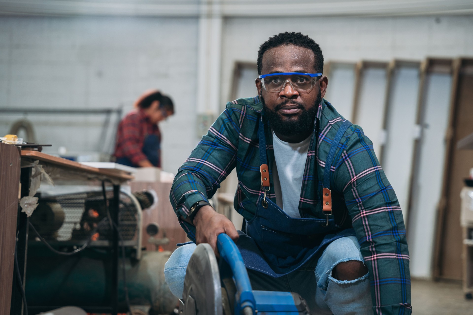 Carpenter crafting wooden furniture in a joinery workshop.